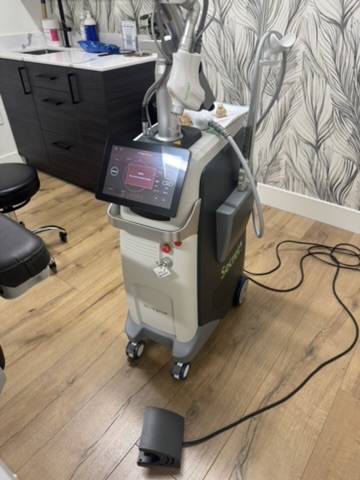 Modern dermatology and medspa treatment room with an aesthetic laser platform